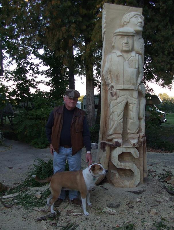 Chainsaw carving of man and dog
